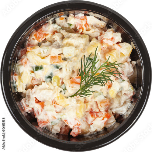 Fresh salad in a disposable round plastic black bowl top view on a white background