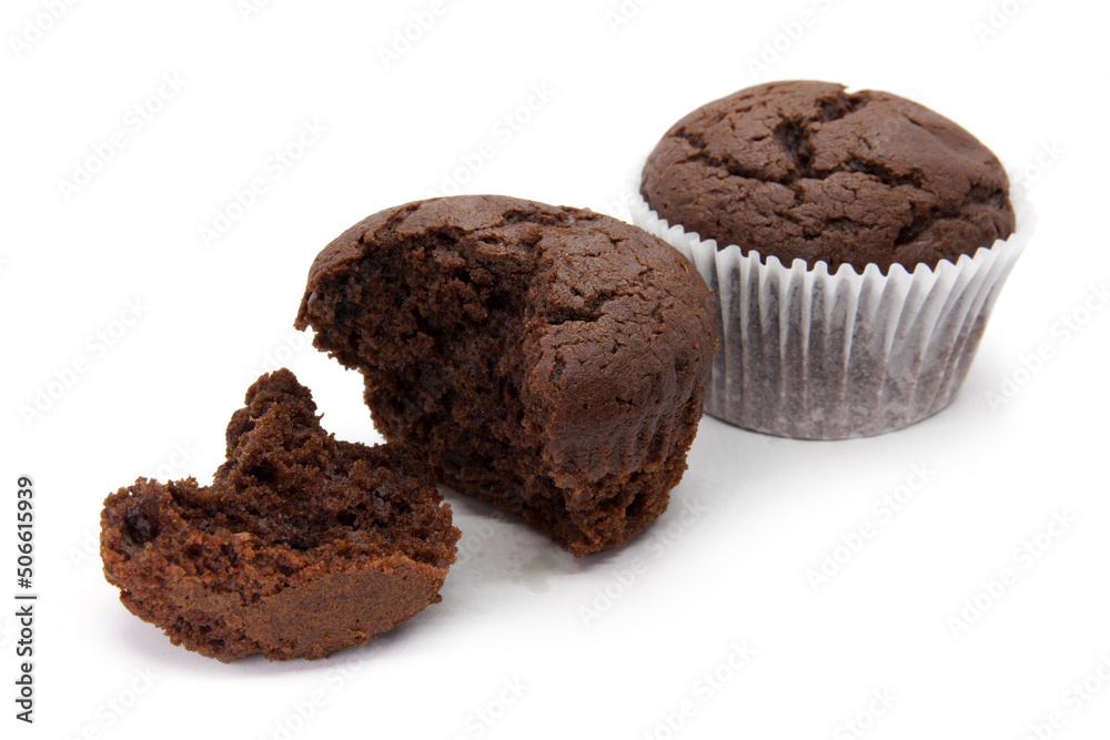 Chocolate muffins with napkin and two half on the white background Chocolate muffins with napkin and two half on the white background