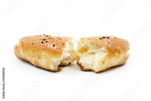 Open baked bread in half isolated on white background