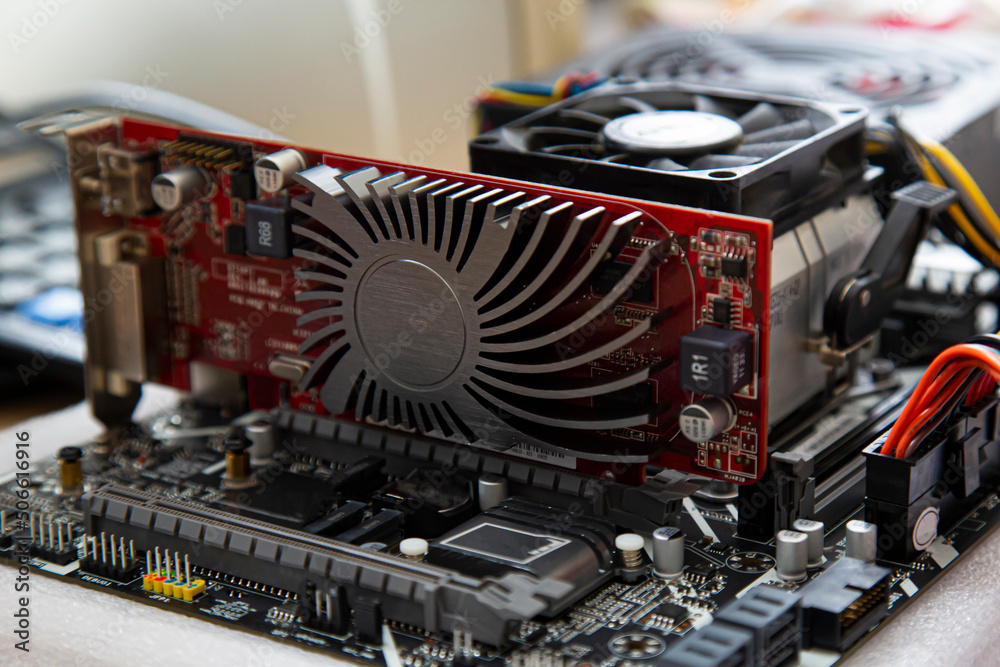 red video card with a passive cooler on a laboratory bench in a computer motherboard red video card with a passive cooler on a laboratory bench in a computer motherboard