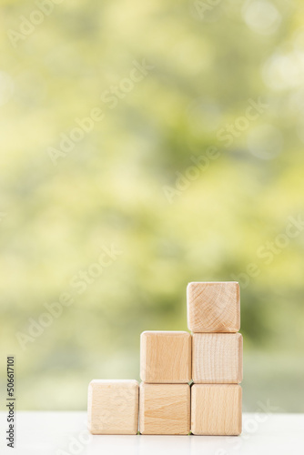 Group of wooden cube block on green summer background with copy space