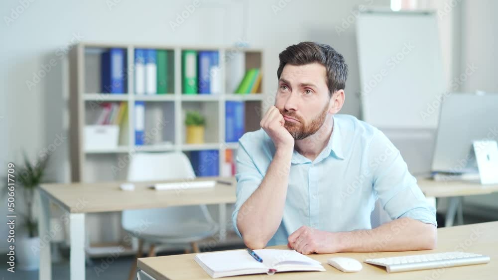 Bored sleepy office worker sitting at work workplace at computer desk leaning on hand yawning. Tired man. Exhausted Businessman employee. Portrait Depressed, unhappy, workless male manager. indoor Bored sleepy office worker sitting at work workplace at computer desk leaning on hand yawning. Tired man. Exhausted Businessman employee. Portrait Depressed, unhappy, workless male manager. indoor
