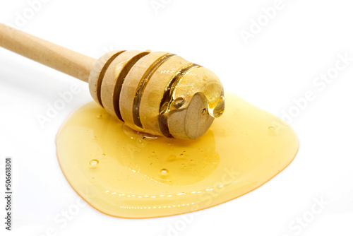  Honey dipper and honey drop on white background