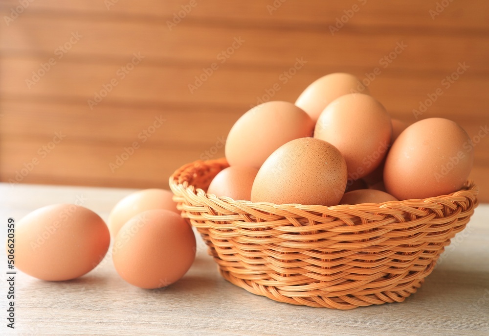 Eggs in a brown basket are placed on the table. Eggs in a brown basket are placed on the table.