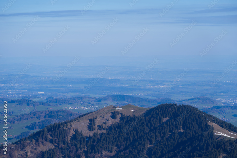 Panoramic landscape with rocks and hills seen from Säntis peak at Alpstein Mountains on a sunny spring day. Photo taken April 19th, 2022, Säntis, Switzerland.