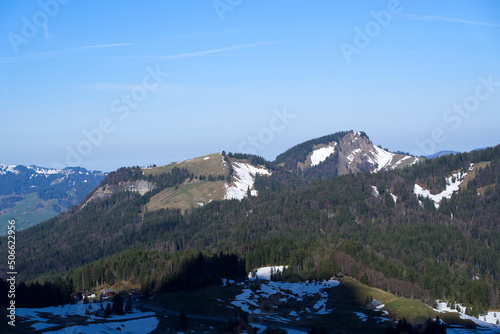 Panoramic landscape with rocks and hills seen from Säntis peak at Alpstein Mountains on a sunny spring day. Photo taken April 19th, 2022, Säntis, Switzerland.