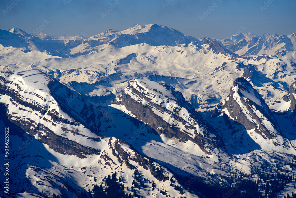 Aerial view over the Swiss Alps with Churfirsten and Toggenburg Valley seen from Säntis peak at Alpstein Mountains on a sunny spring day. Photo taken April 19th, 2022, Säntis, Switzerland.