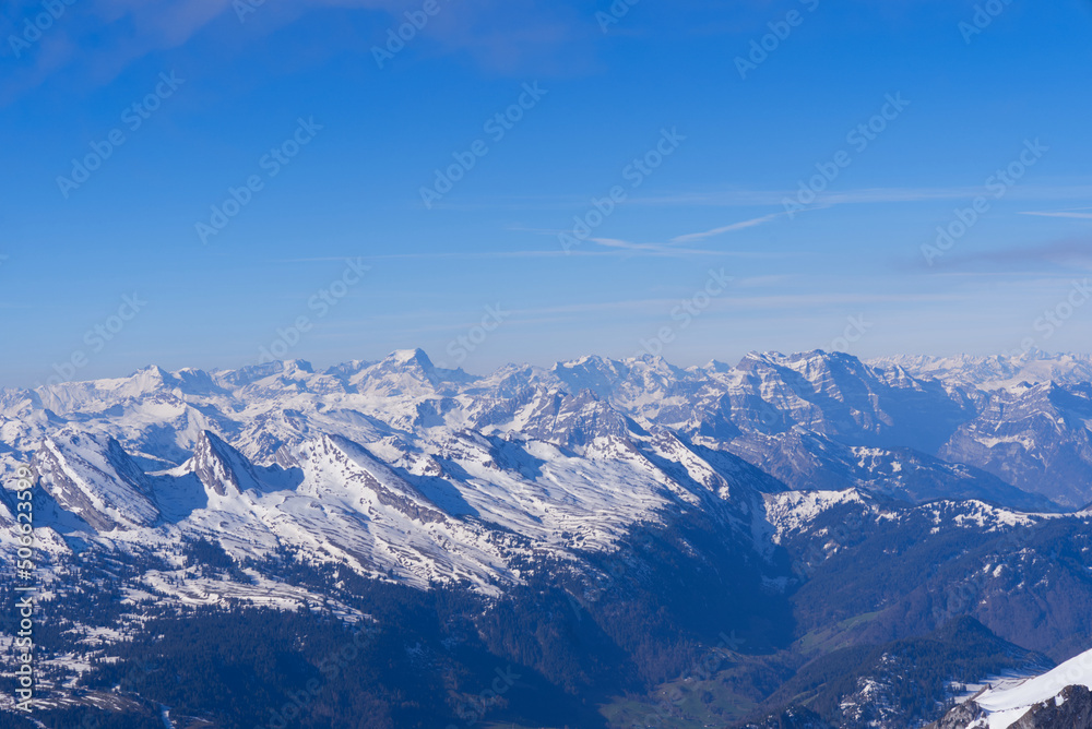 Aerial view over the Swiss Alps seen from Säntis peak at Alpstein Mountains on a sunny spring day. Photo taken April 19th, 2022, Säntis, Switzerland.