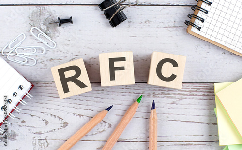 RFC Request for Comments text on wooden block with office tools on the wooden background photo