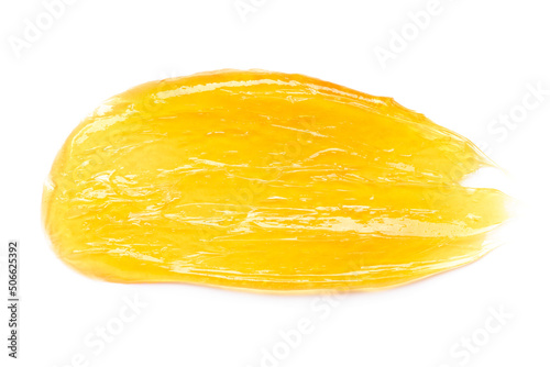 Transparent yellow gel cream smear smudge macro isolated on white background top view