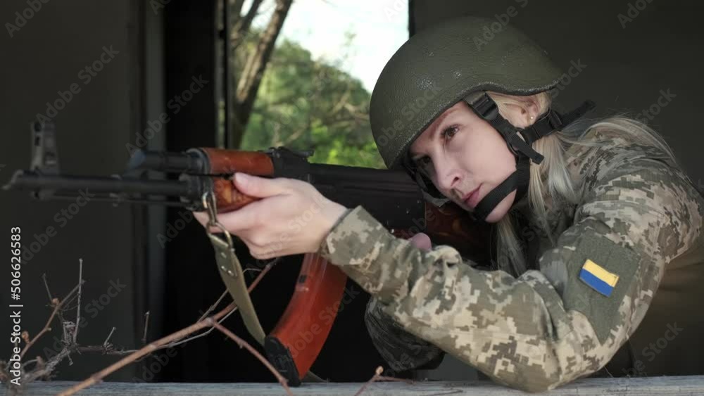 Young Ukrainian female soldier in camouflage uniform with an assault ...