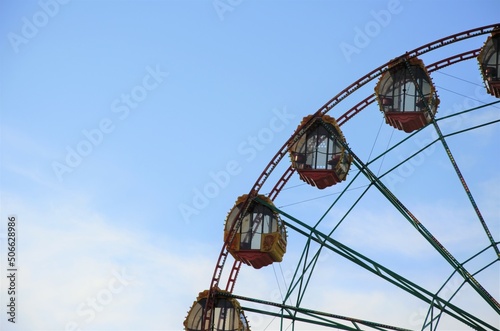 part of the Ferris wheel against the blue sky. Attraction. geometric background