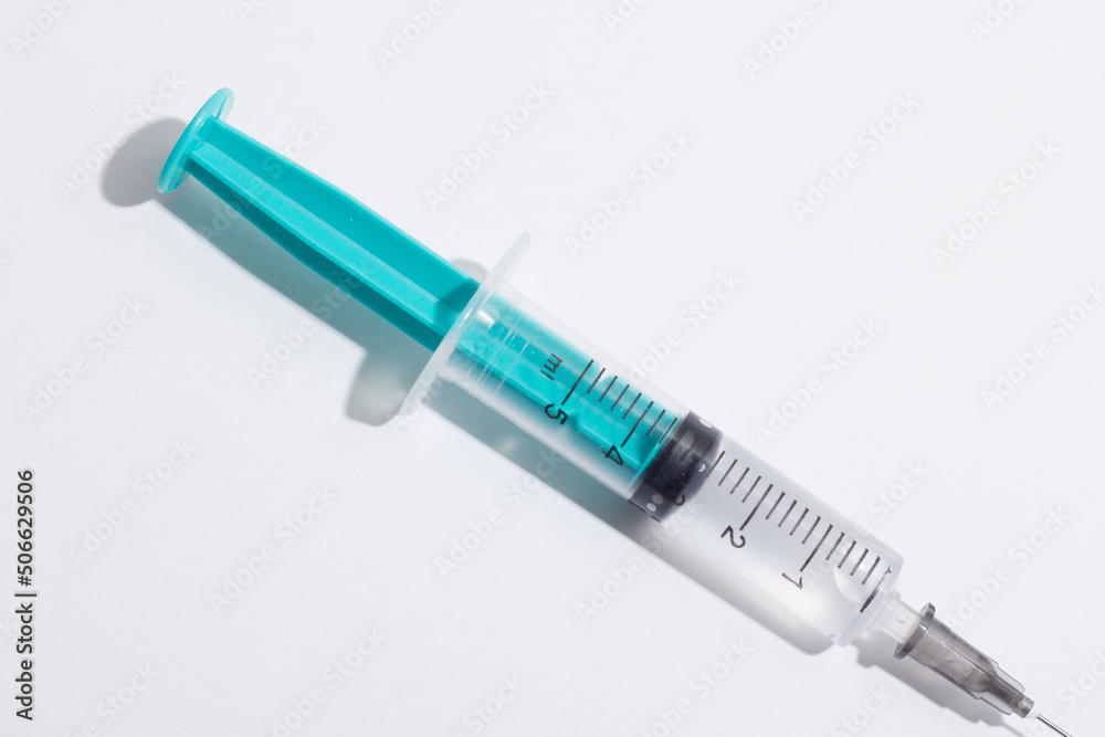 Medical syringe on a white background. A syringe for injection. The concept of health and beauty Medical syringe on a white background. A syringe for injection. The concept of health and beauty