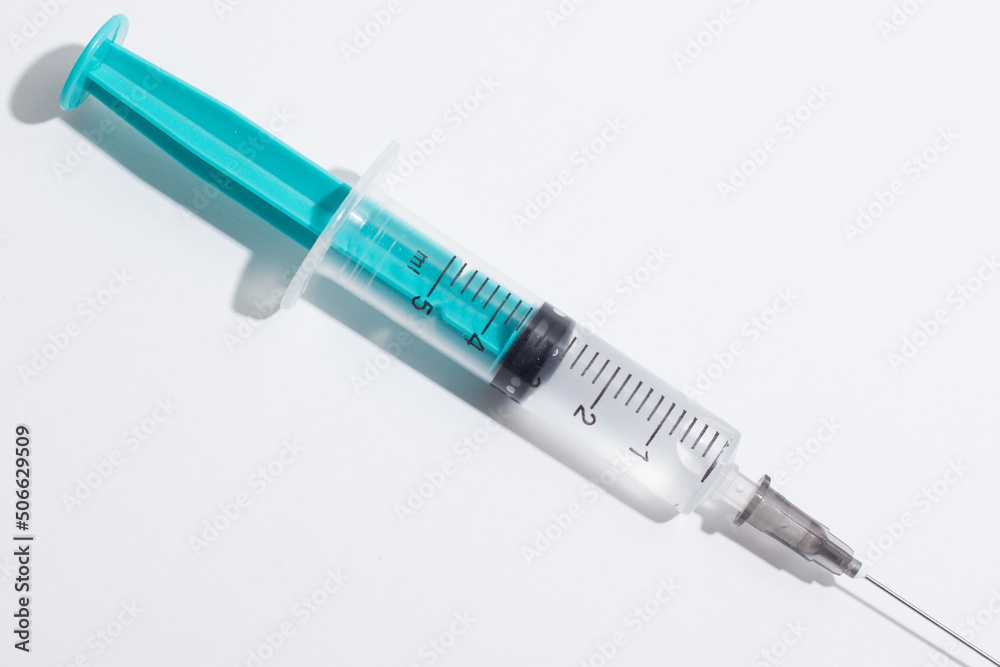 Medical syringe on a white background. A syringe for injection. The concept of health and beauty Medical syringe on a white background. A syringe for injection. The concept of health and beauty