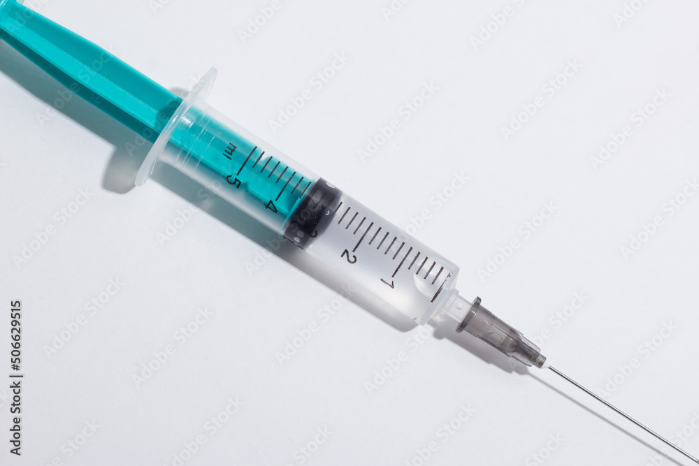 Medical syringe on a white background. A syringe for injection. The concept of health and beauty Medical syringe on a white background. A syringe for injection. The concept of health and beauty