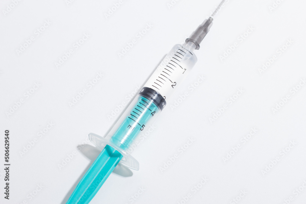 Medical syringe on a white background. A syringe for injection. The concept of health and beauty Medical syringe on a white background. A syringe for injection. The concept of health and beauty