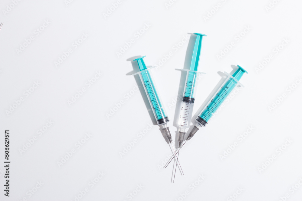Medical syringe on a white background. A syringe for injection. The concept of health and beauty Medical syringe on a white background. A syringe for injection. The concept of health and beauty