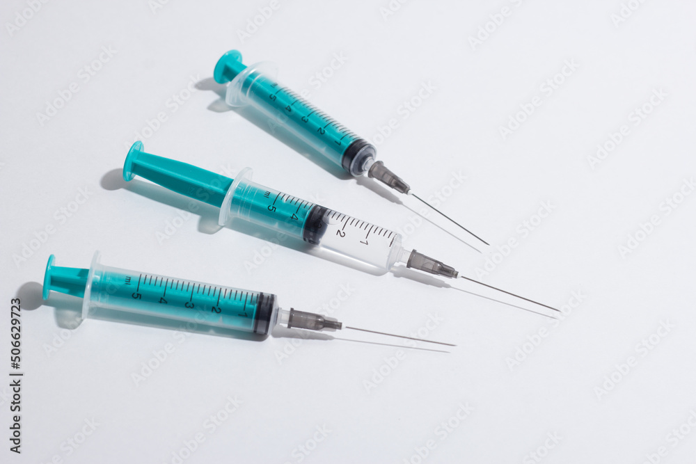 Medical syringe on a white background. A syringe for injection. The concept of health and beauty Medical syringe on a white background. A syringe for injection. The concept of health and beauty