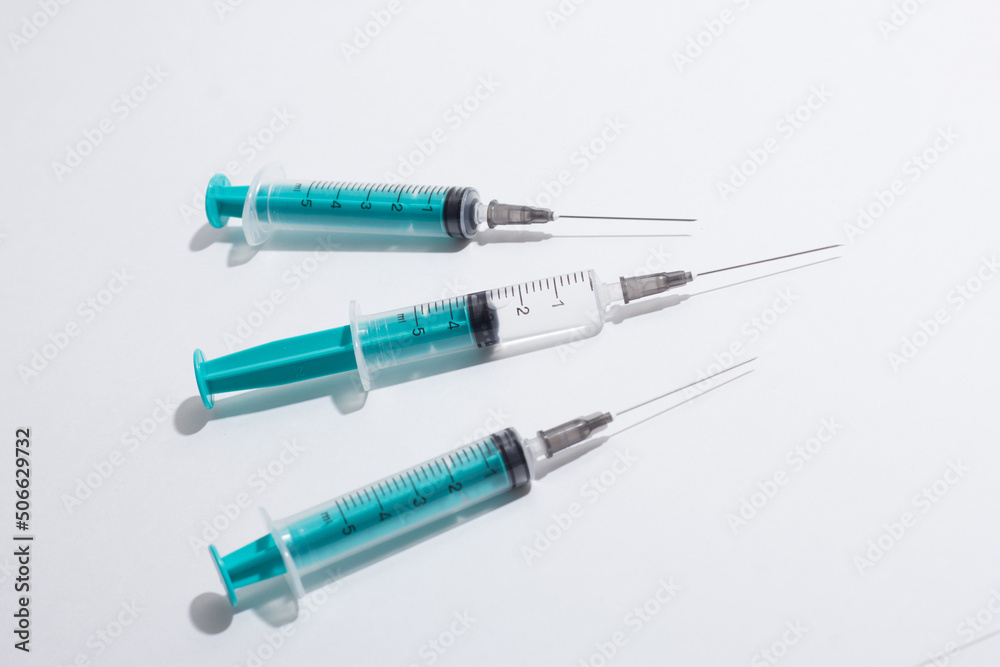 Medical syringe on a white background. A syringe for injection. The concept of health and beauty Medical syringe on a white background. A syringe for injection. The concept of health and beauty