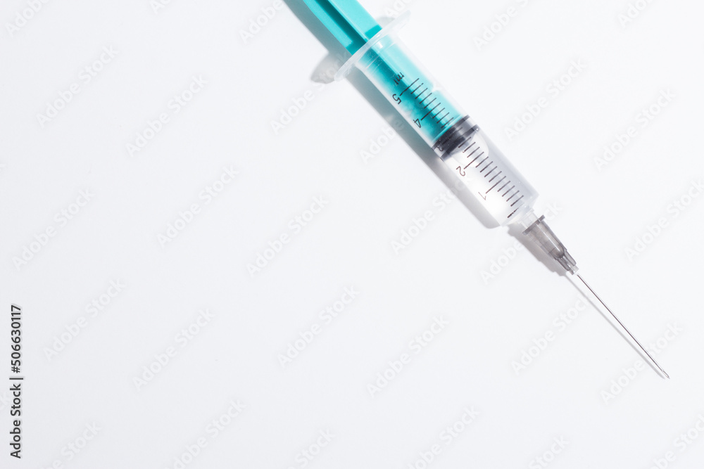 Medical syringe on a white background. A syringe for injection. The concept of health and beauty Medical syringe on a white background. A syringe for injection. The concept of health and beauty