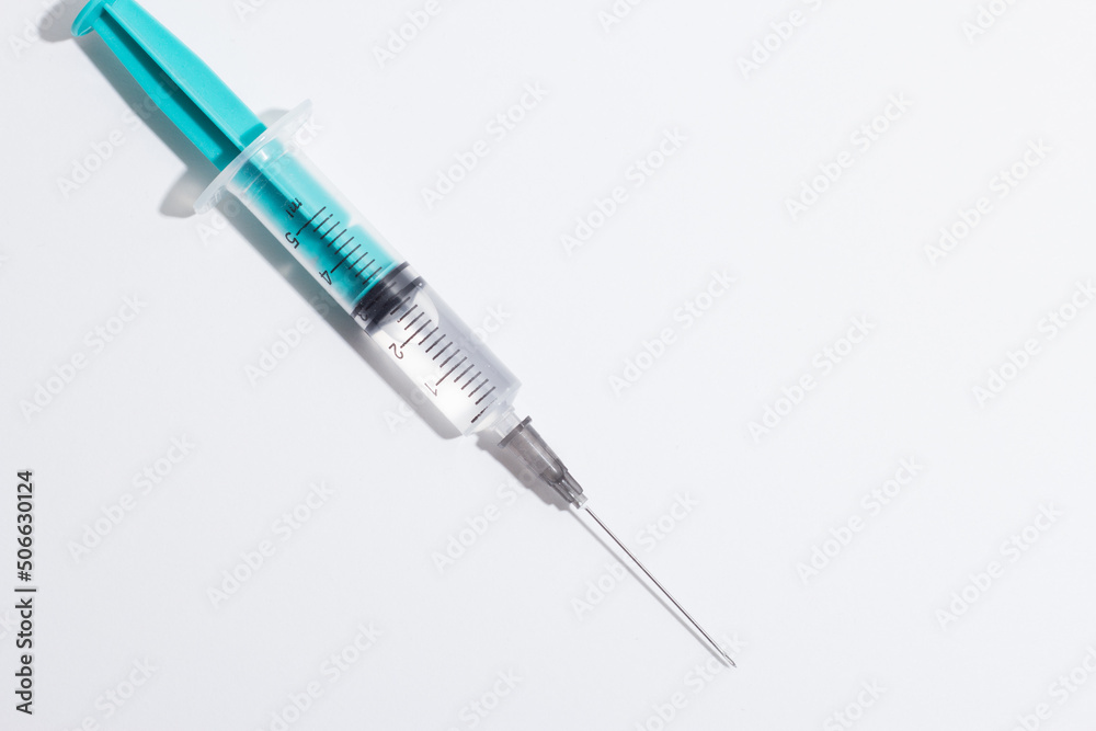 Medical syringe on a white background. A syringe for injection. The concept of health and beauty Medical syringe on a white background. A syringe for injection. The concept of health and beauty