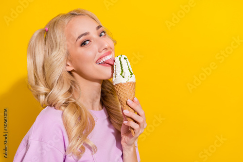 Profile portrait of cheerful nice person tongue lick ice cream toothy smile isolated on yellow color background
