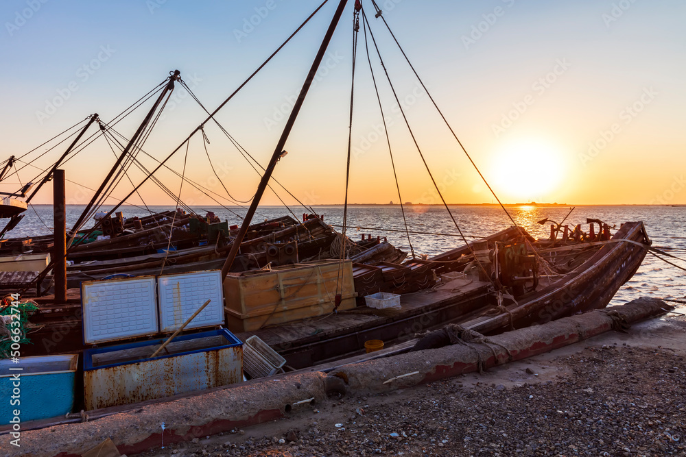 Wooden fishing boats on the coast in the evening