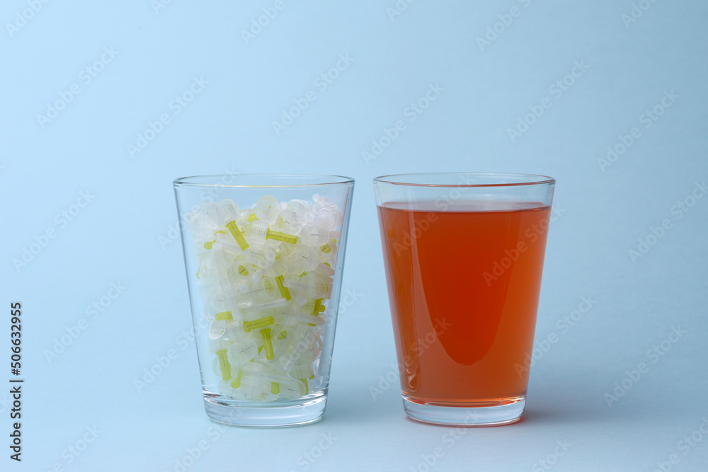 Insulin needles and glass of sweet soda juice drink Insulin needles and glass of sweet soda juice drink