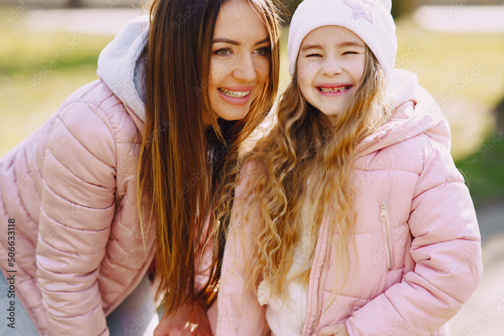 Fototapeta premium Mother with daughter playing in a spring park
