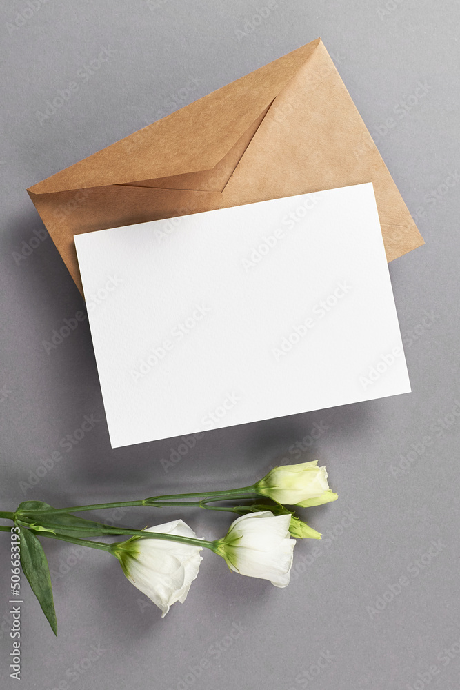 Invitation or greeting card mockup with envelope and white eustoma flowers Invitation or greeting card mockup with envelope and white eustoma flowers