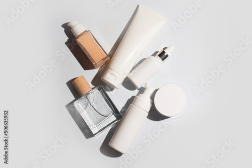 mockup of perfume skin care bottle cosmetic tube of beauty makeup facial, treatment cleanser face foam, beauty healthcare branding packaging in water splash