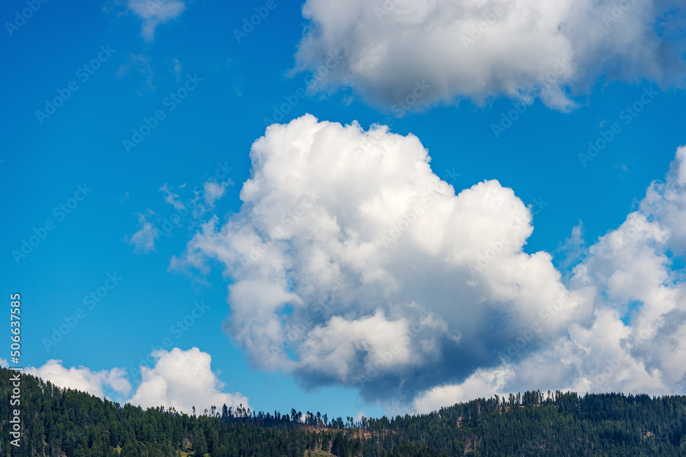 Beautiful storm clouds, cumulus clouds or cumulonimbus against a clear blue sky. Italian Alps, Italy, Europe. Beautiful storm clouds, cumulus clouds or cumulonimbus against a clear blue sky. Italian Alps, Italy, Europe.
