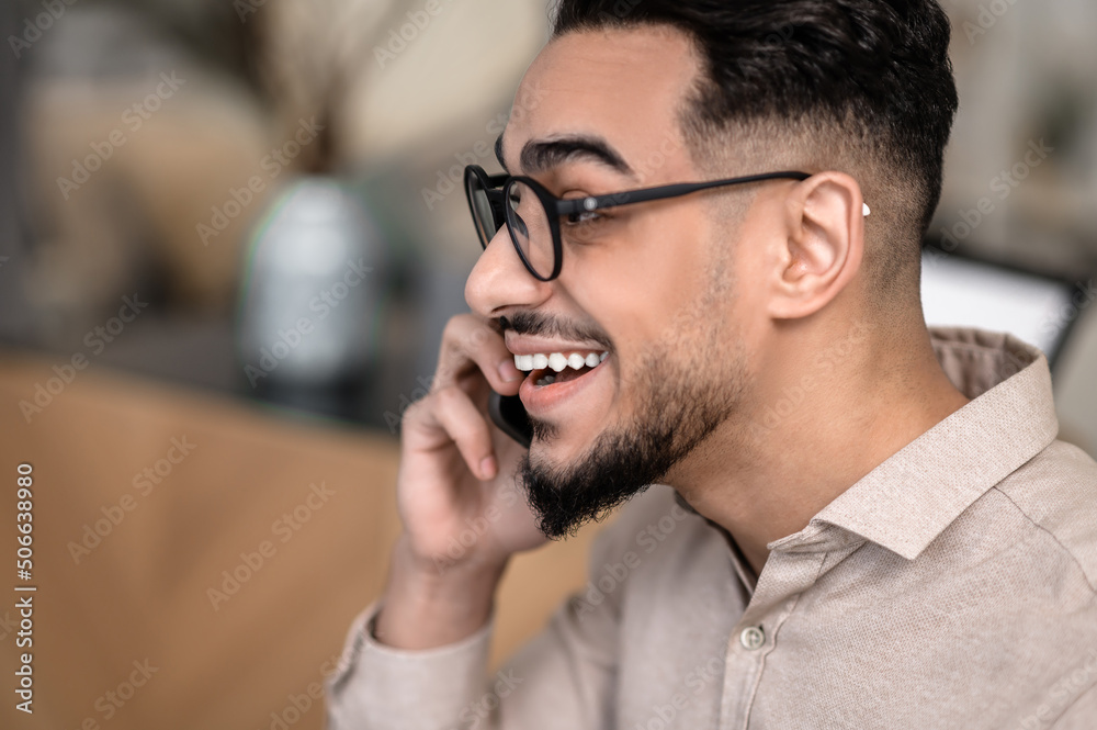 A young good-looking businessman talking on the phone A young good-looking businessman talking on the phone