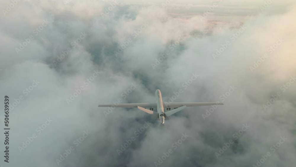 A military drone with full armament flies in the clouds. Sunrise, the beginning of a military mission.