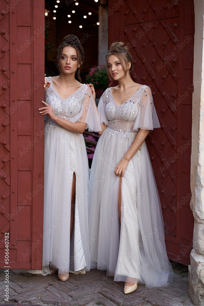 European girls bridesmaids in silver dresses having fun