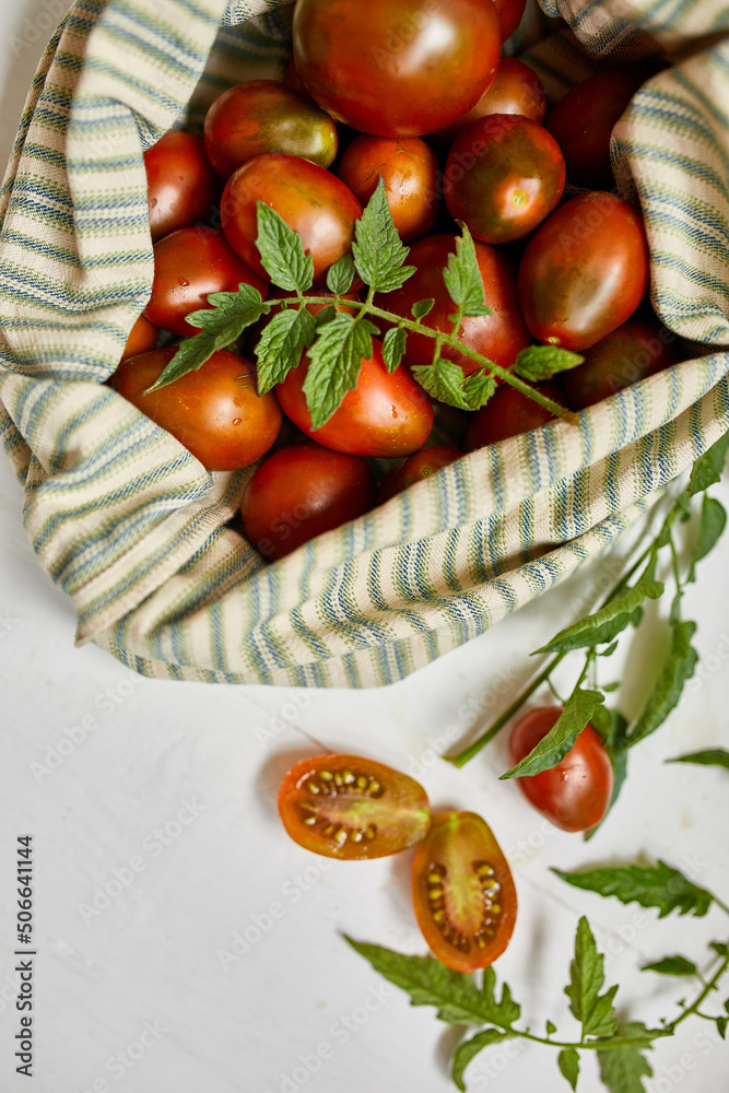 Market delivary of brown tomatoes in eco textile bag, Zero waste, Eco background, Assortment of tomatoes, local farmers market, Fresh vegetables, harvest .Top view, copy space. Market delivary of brown tomatoes in eco textile bag, Zero waste, Eco background, Assortment of tomatoes, local farmers market, Fresh vegetables, harvest .Top view, copy space.