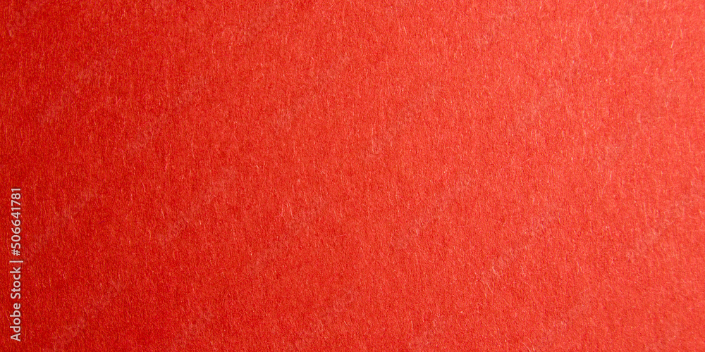 Fototapeta premium red background with thick paper texture. uneven lighting. Banner for insertion into site. Place for text cope space. Horizontal image.