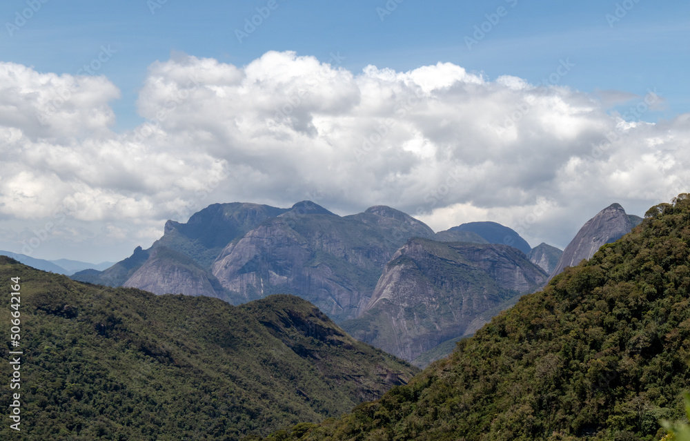 Mountain valley panorama with famous summits from Tres Picos State Park, dense clouds in the background, Teresópolis, Rio de Janeiro, Brazil