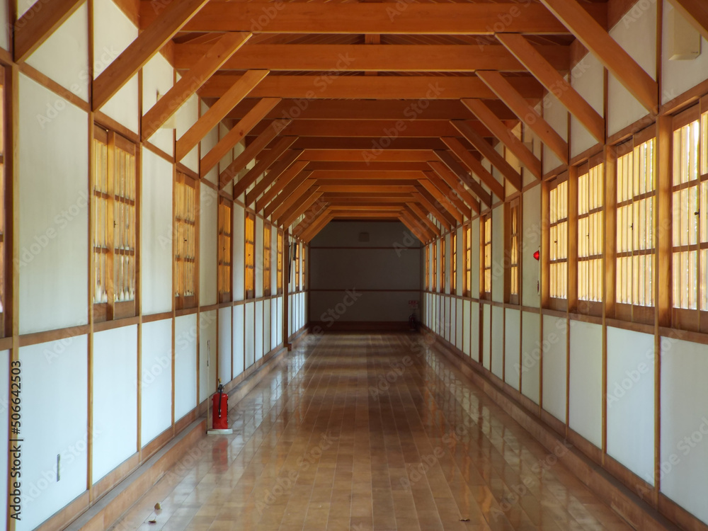 Zen temple's long corridor consists of white and brown colors.