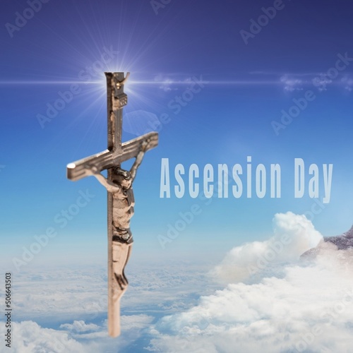 Composite of ascension day text and crucifix against blue sky on sunny day, copy space