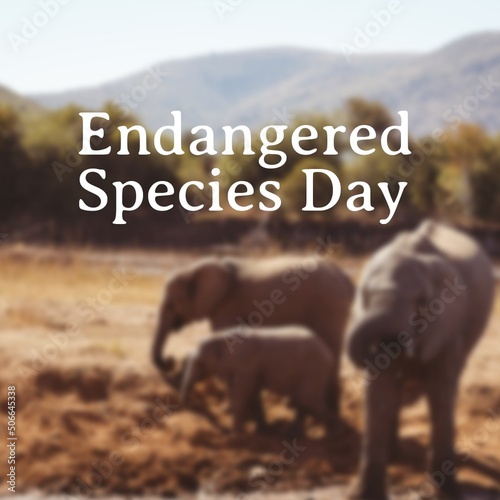 Composite of elephant family standing on land against mountains and endangered species day text
