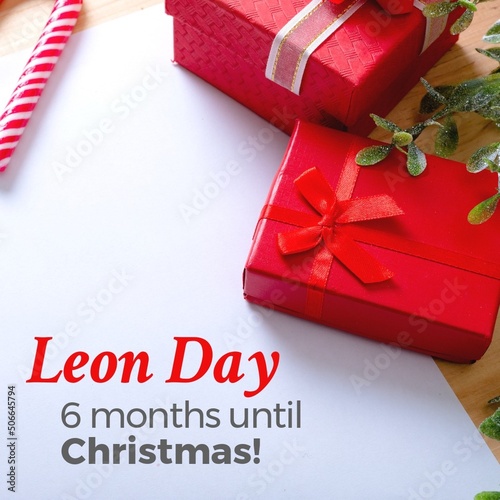 Composite of leon day and 6 months until christmas text with christmas presents on white paper