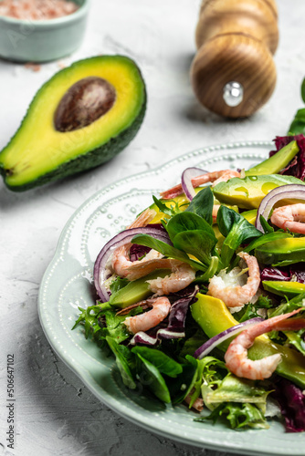 salad with fresh Avocado, Shrimps lettuce green mix and olive oil, lemon dressing. healthy food, Delicious breakfast or snack, vertical image. top view