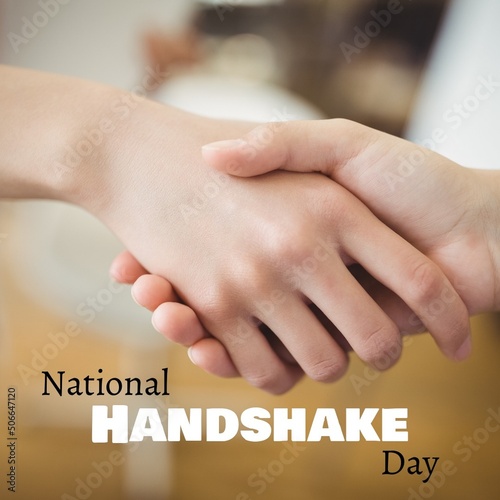Cropped hands of caucasian young females doing handshake with digital national handshake day text