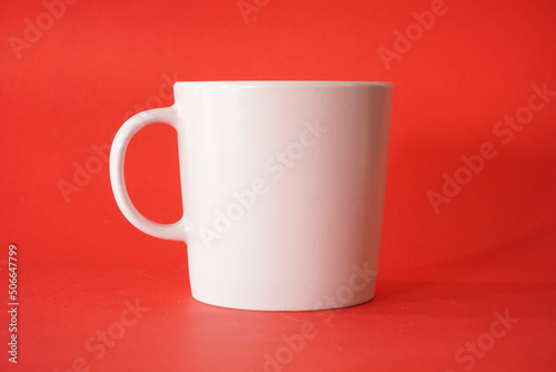 empty white cup on red background