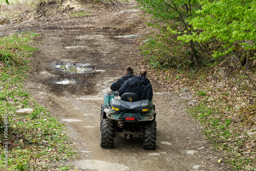 two men riding ATV in mountains