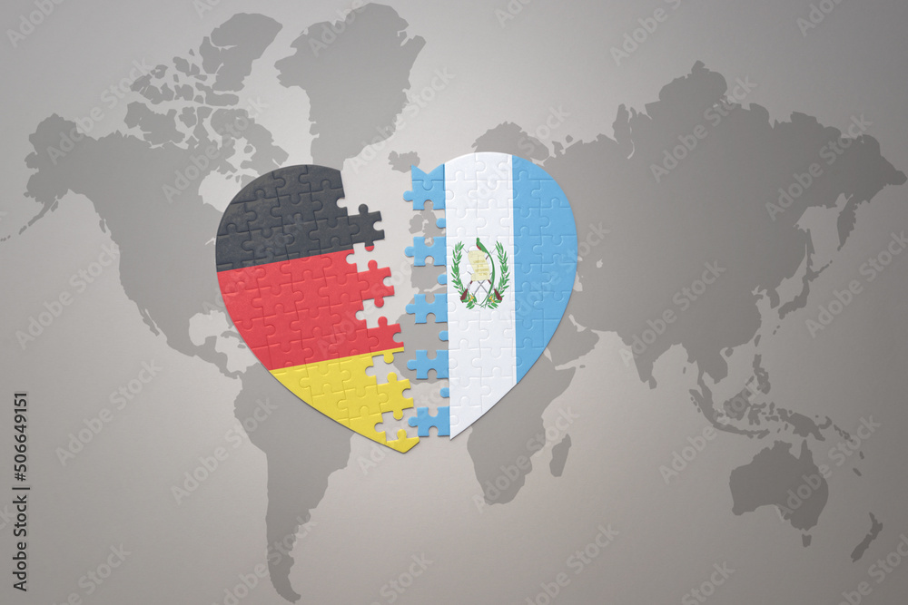 Fototapeta premium puzzle heart with the national flag of guatemala and germany on a world map background. Concept.