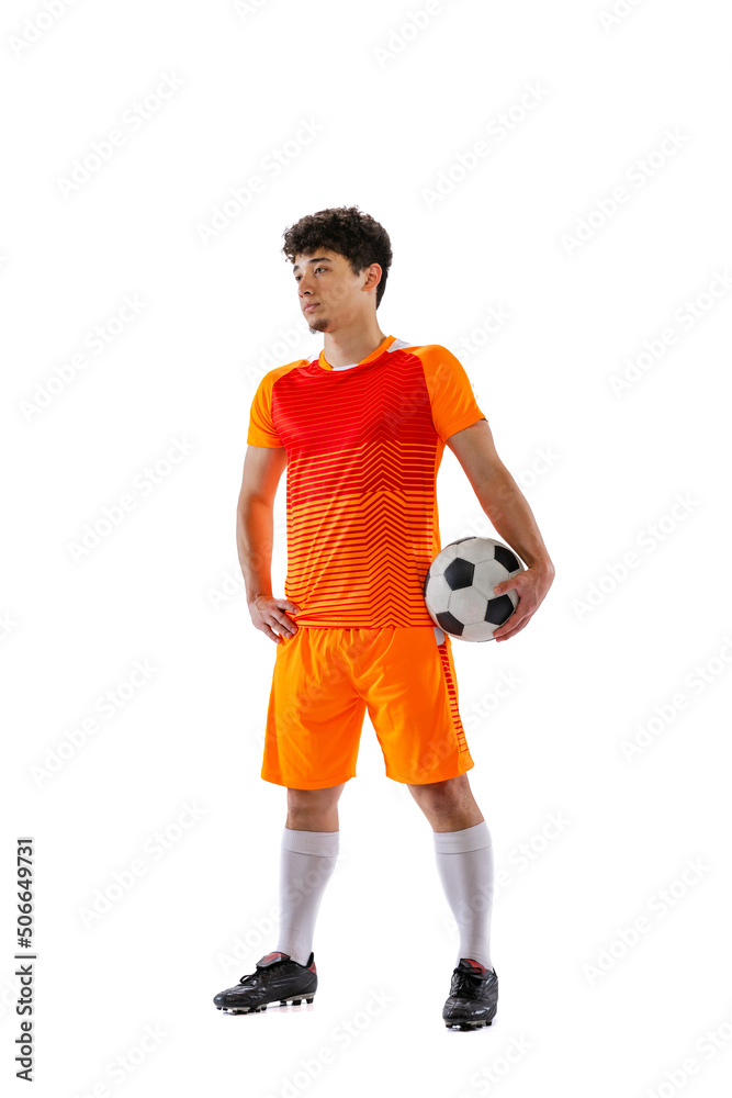 Portrait of young man, asian football, soccer player posing with ball isolated on white studio background. Concept of sport, match, active lifestyle, goal and hobby