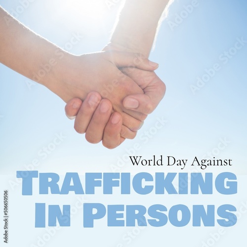 Composite of caucasian people holding hands and world day against trafficking in persons text