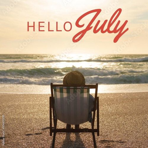 Composite of hello july text and person wearing hat relaxing on deckchair at beach during sunset photo